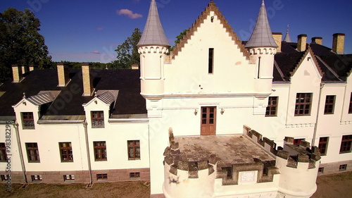 The closer look of the white big mansion of Alatskivi. The big white mansion in the middle of the forest photo