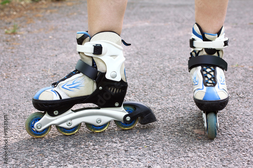 Close-up view on teenager holding roller skate photo