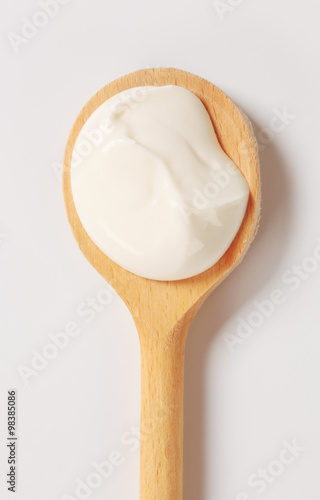 Creme fraiche on wooden spoon photo