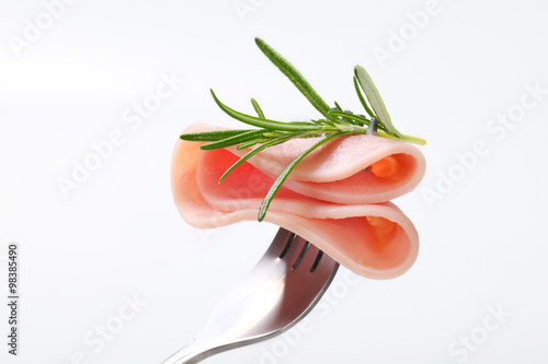thin slice of ham on a fork