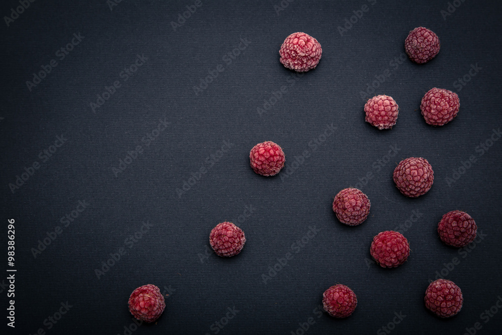 Fototapeta premium Frozen Raspberry On Black Background