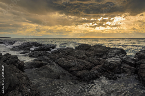 Dramatic sunset at the ocean with boulder rocks © mastersky