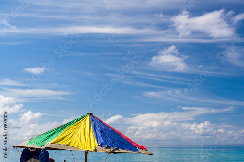 Colorful Umbrella on a Beach in the Caribbean © dfikar