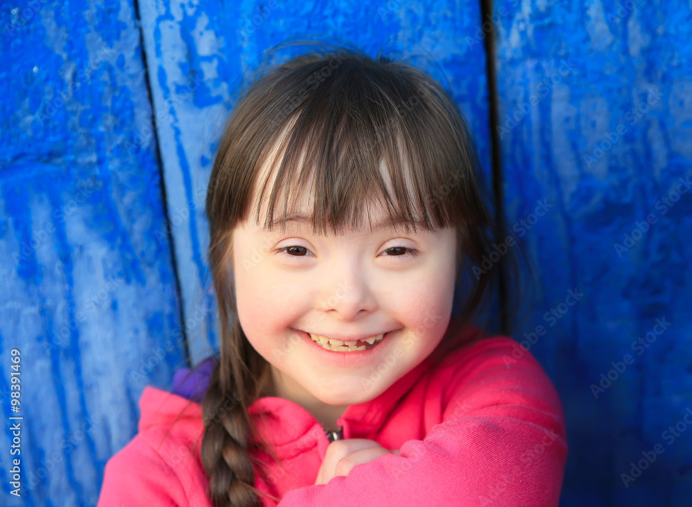 Young girl smiling on background of the blue wall. Young girl smiling on background of the blue wall.
