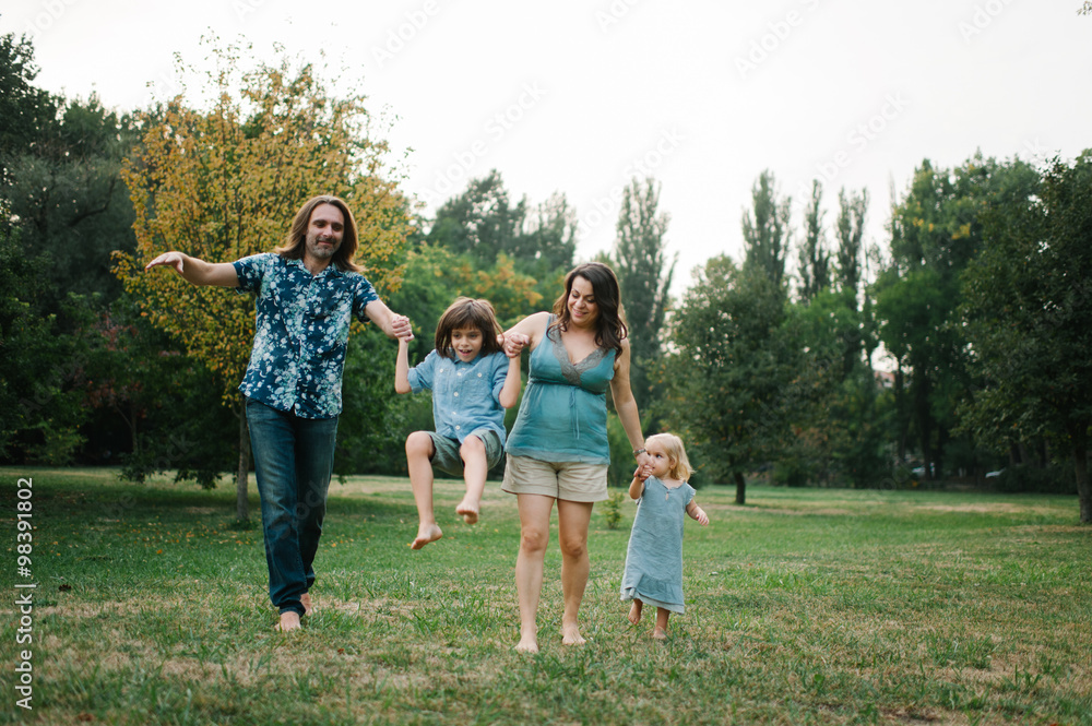 Happy young hipster family having fun while running, bowl, rising up, piggyback ride their children in park on summer sunset
Happy young hipster family having fun while running, bowl, rising up, piggyback ride their children in park on summer sunset