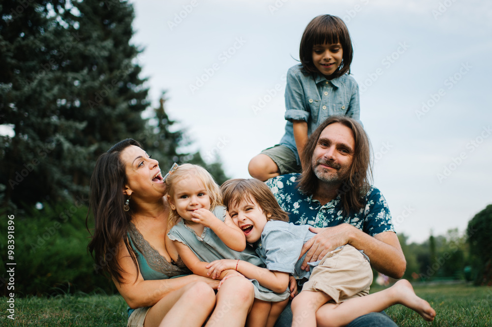 Happy young hipster family having fun, bowl, rising up, piggyback ride their children in park on summer sunset
Happy young hipster family having fun, bowl, rising up, piggyback ride their children in park on summer sunset