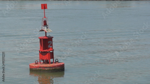 red buoy in the sea as a warning signal to mariner