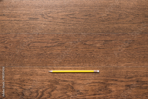 yellow pencils on wooden background