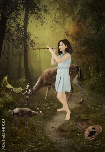 Little girl playing the flute in a forest surrounded by deers