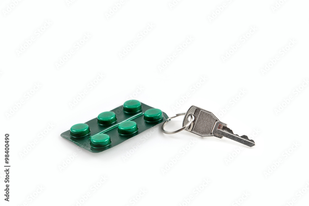 pills and key isolated on white background pills and key isolated on white background