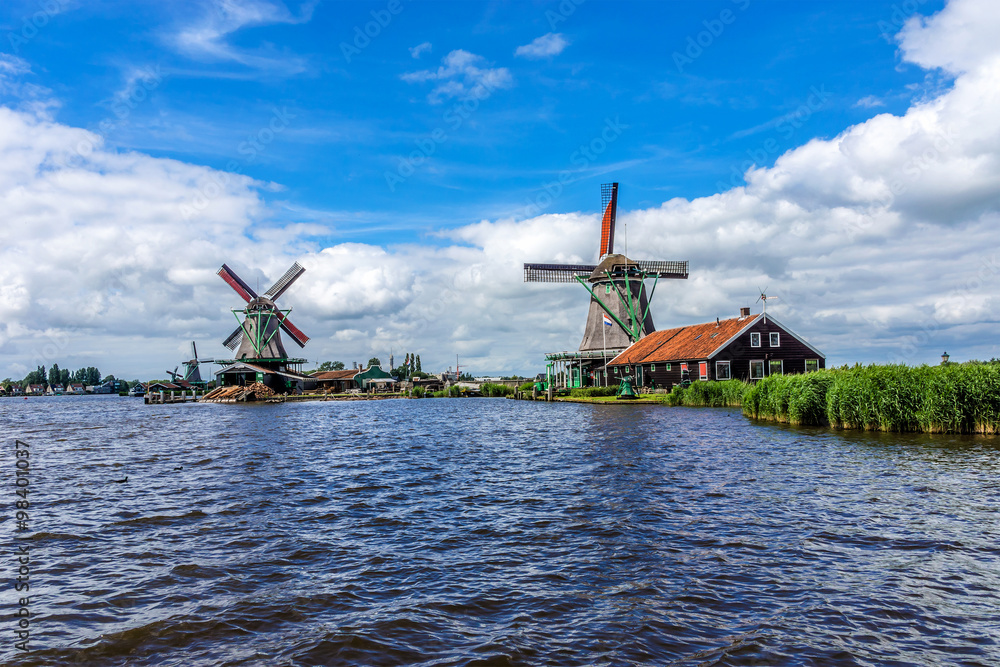 Naklejka premium Traditional Dutch old wooden windmill. Zaanse Schans, Zaandam.
