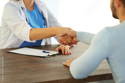 Male patient visiting doctor on light background