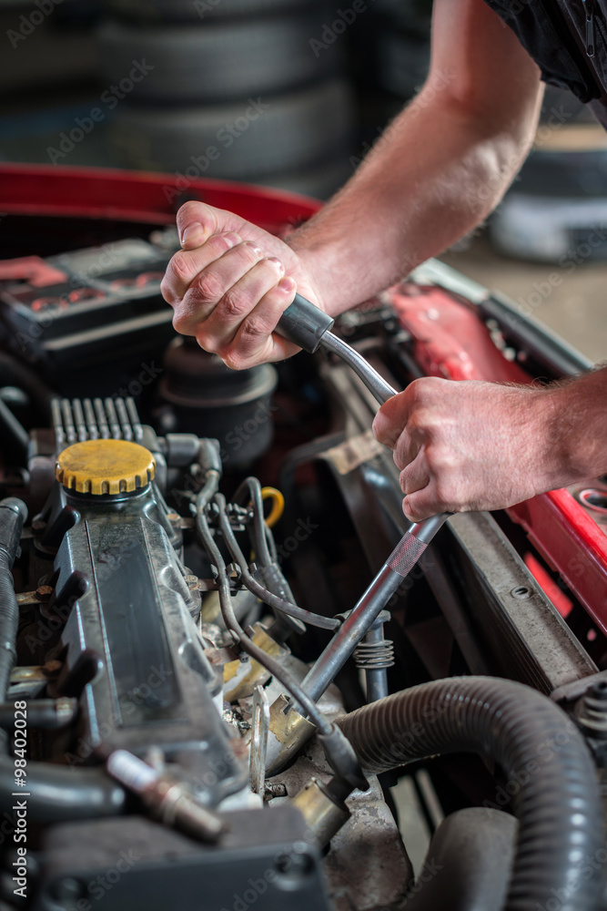 Car mechanic in auto repair service, starting ignition plug Car mechanic in auto repair service, starting ignition plug