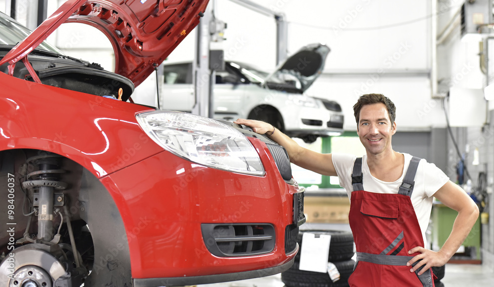 Car mechanic working in repair garage Car mechanic working in repair garage