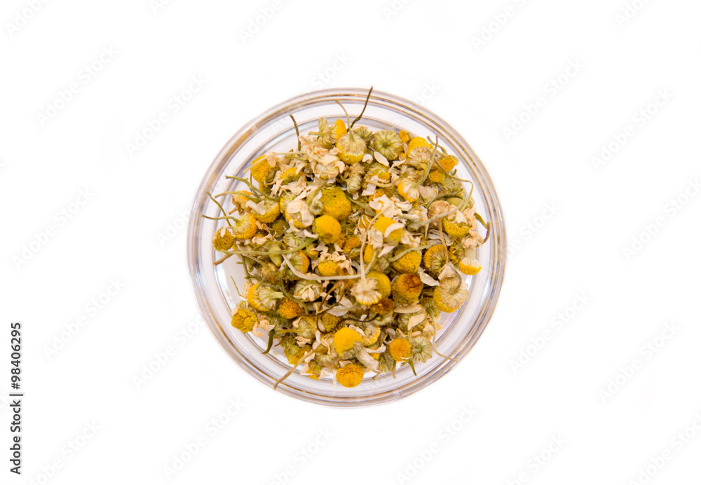 Chamomile flower on bowl on a white background seen from above Chamomile flower on bowl on a white background seen from above
