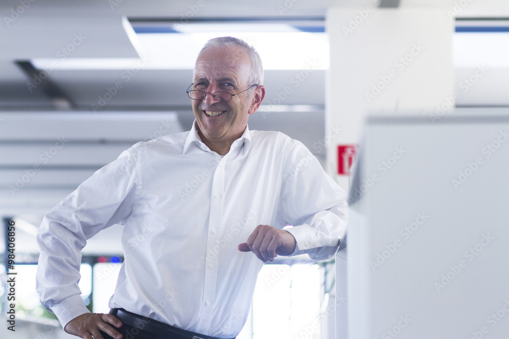 Smiling businessman in open space office Smiling businessman in open space office