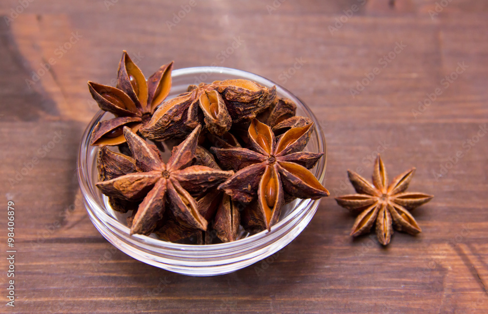 Star anise on bowl on wooden table Star anise on bowl on wooden table