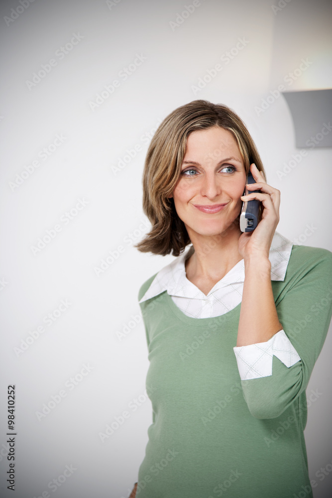 Portrait of smiling woman telephoning in the kitchen Portrait of smiling woman telephoning in the kitchen