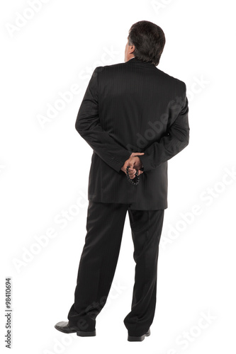 Back of a mature business man standing isolated on white background