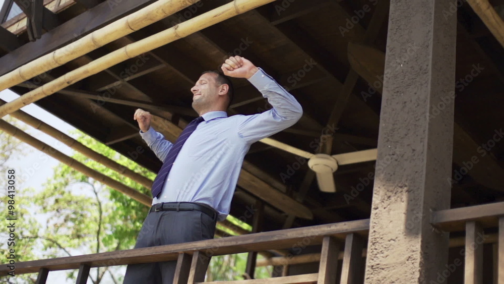 Happy businessman relaxing and stretching on terrace, super slow motion 240fps
Happy businessman relaxing and stretching on terrace, super slow motion 240fps