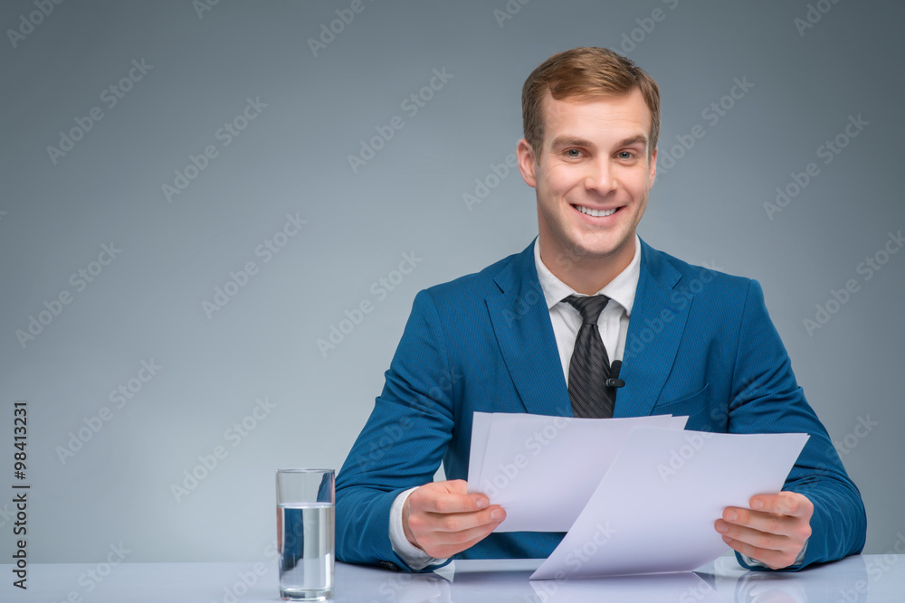Smiling newscaster during broadcasting. Smiling newscaster during broadcasting.