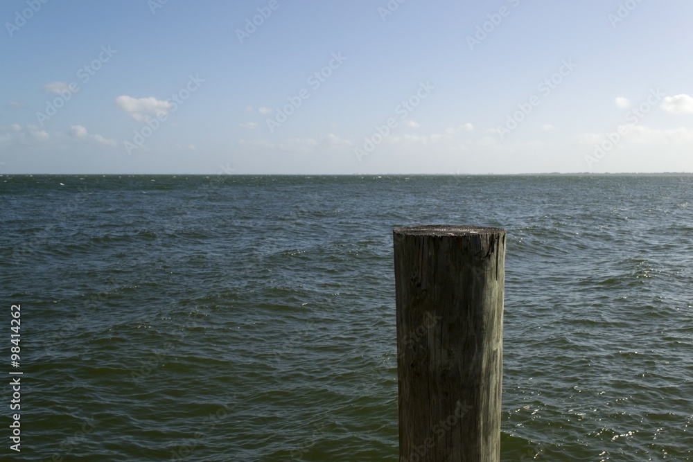 Peaceful seascape - water, sky and pillar