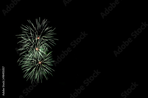 Green fireworks with black copy space