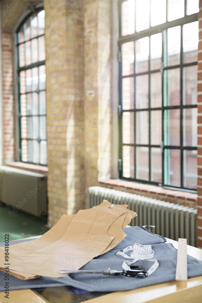 Germany, Berlin, Cut pattern and fabric on table at men's tailor Germany, Berlin, Cut pattern and fabric on table at men's tailor