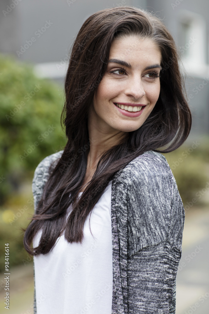 Portrait of smiling young woman with long brown hair Portrait of smiling young woman with long brown hair