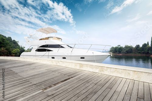 skyline wooden floor and yacht on lake
