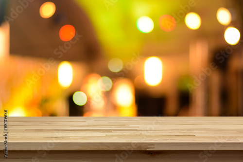 Wood table top on abstract colorful bokeh background at night