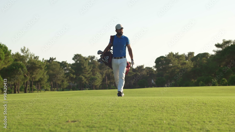 young healthy golfer hitting golf shot with club on course young healthy golfer hitting golf shot with club on course