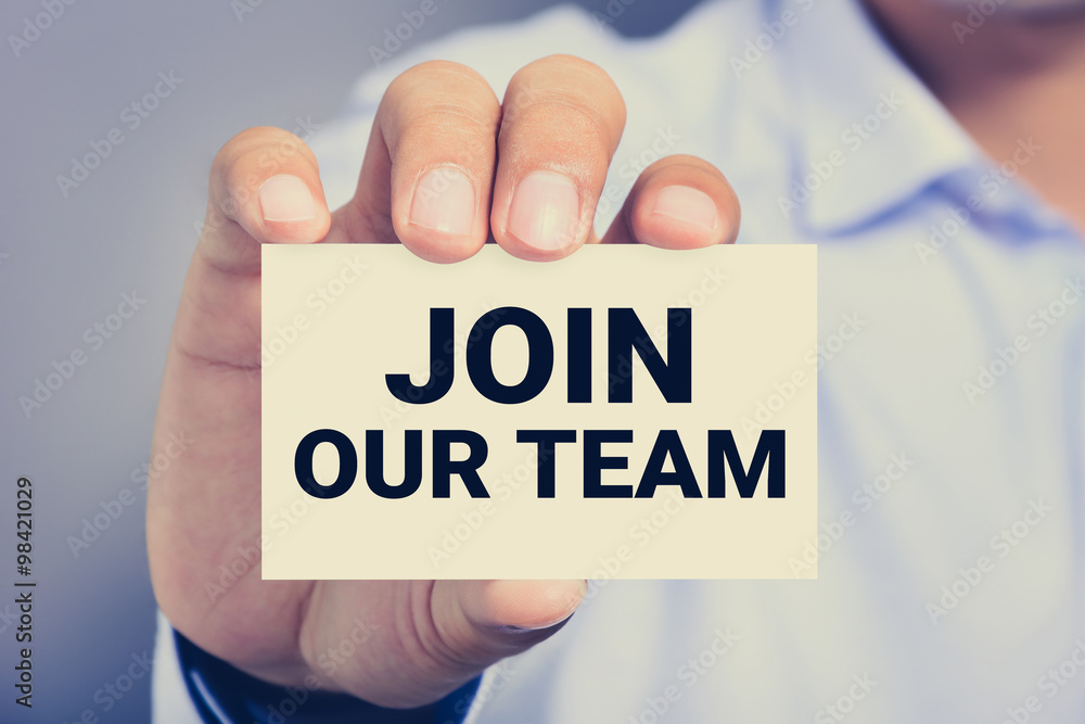 JOIN OUR TEAM, message on business card shown by a man JOIN OUR TEAM, message on business card shown by a man