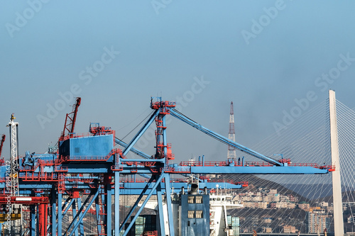 port cranes and pylons of the bridge in Vladivostok Russia