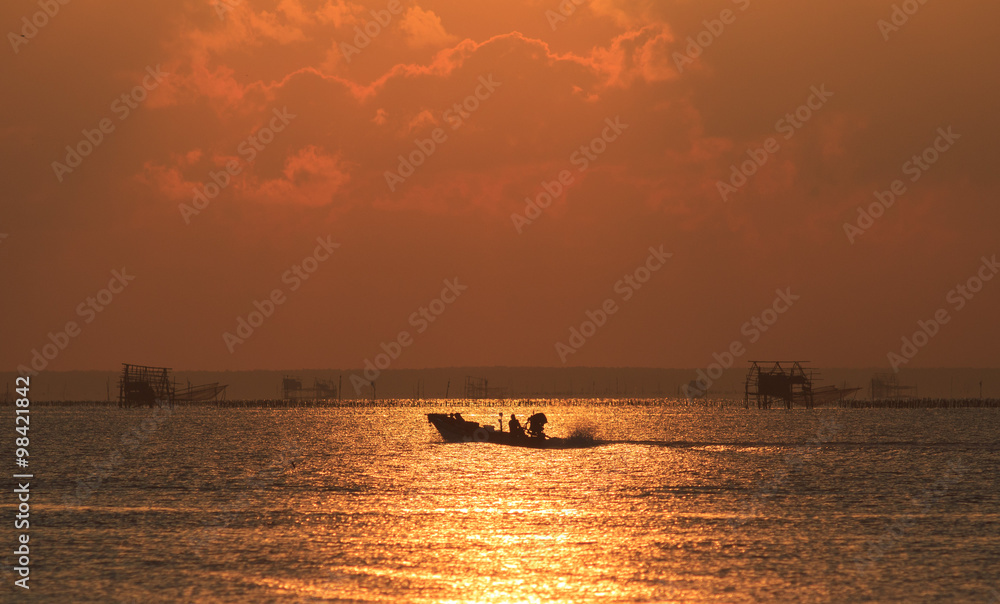 The fisherman ride a long-tailed boat to fishing in the morning.