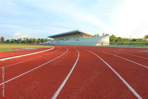 Running track over blue sky and clouds