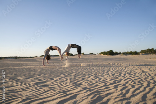 Netherlands, Acrobat couple performing synchronous backflips
