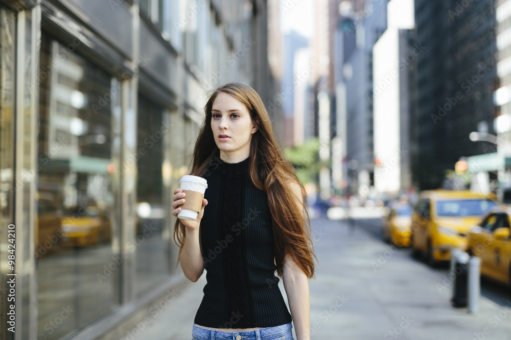 USA, New York City, portrait of young woman with coffee to go USA, New York City, portrait of young woman with coffee to go