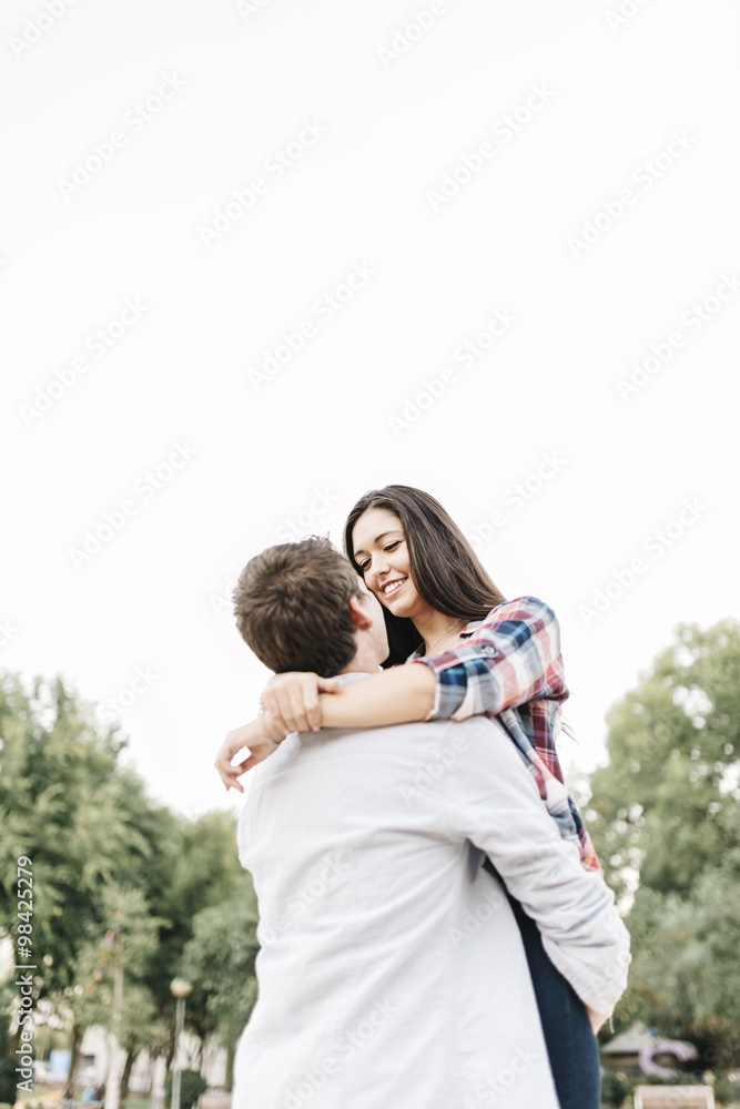 Young couple in love hugging in a park Young couple in love hugging in a park
