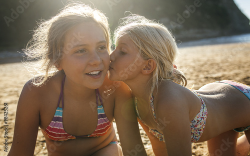 Two sisters having fun together on the beach photo