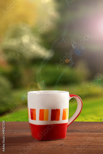 a cup of coffee or tea on garden background
