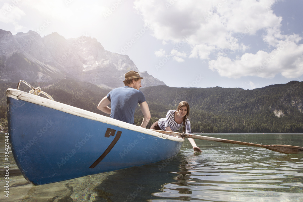 Germany, Bavaria, Eibsee, couple in rowing boat on the lake Germany, Bavaria, Eibsee, couple in rowing boat on the lake