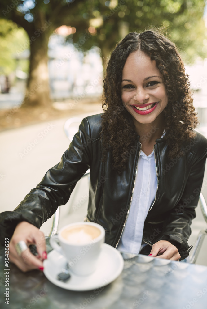Portrait of smiling young woman with cup of coffee Portrait of smiling young woman with cup of coffee