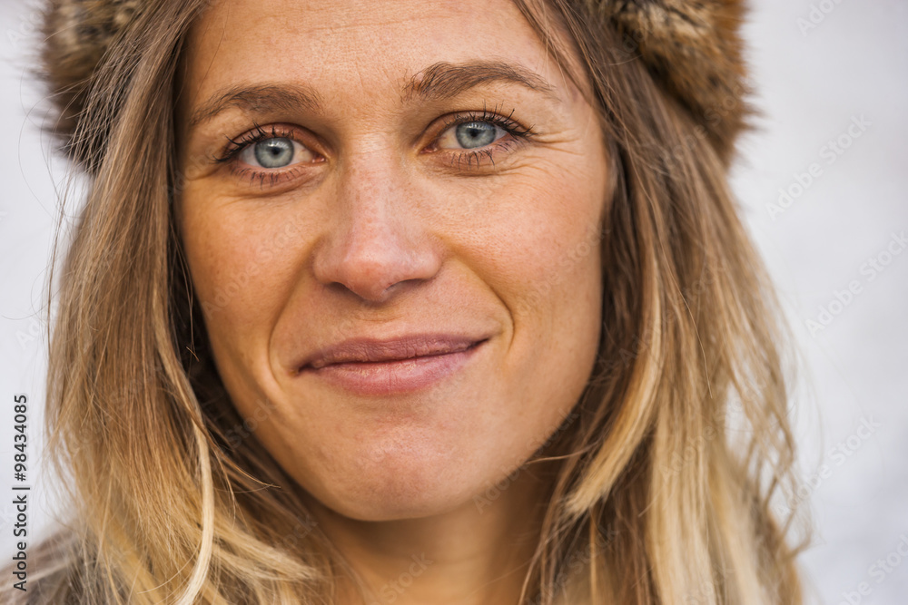 Portrait of smiling blond wearing fur cap Portrait of smiling blond wearing fur cap