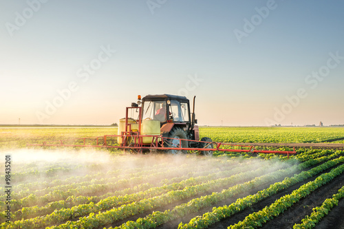Tractor spraying soybean