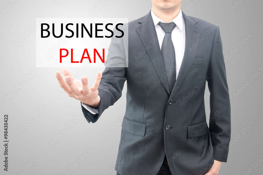 Business plan concept on hand of a businessman in suit Business plan concept on hand of a businessman in suit