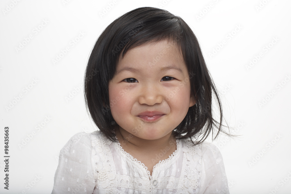 Portrait of little Asian girl smiling, studio shot Portrait of little Asian girl smiling, studio shot