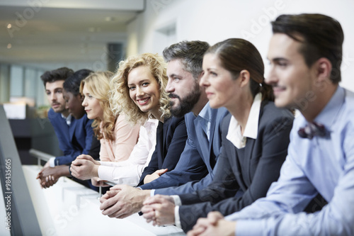 Germany, Neuss, Group of business people, leaning on railing photo