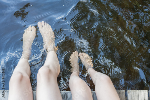 Finland, lake Saimaa, children splashing feet in water photo