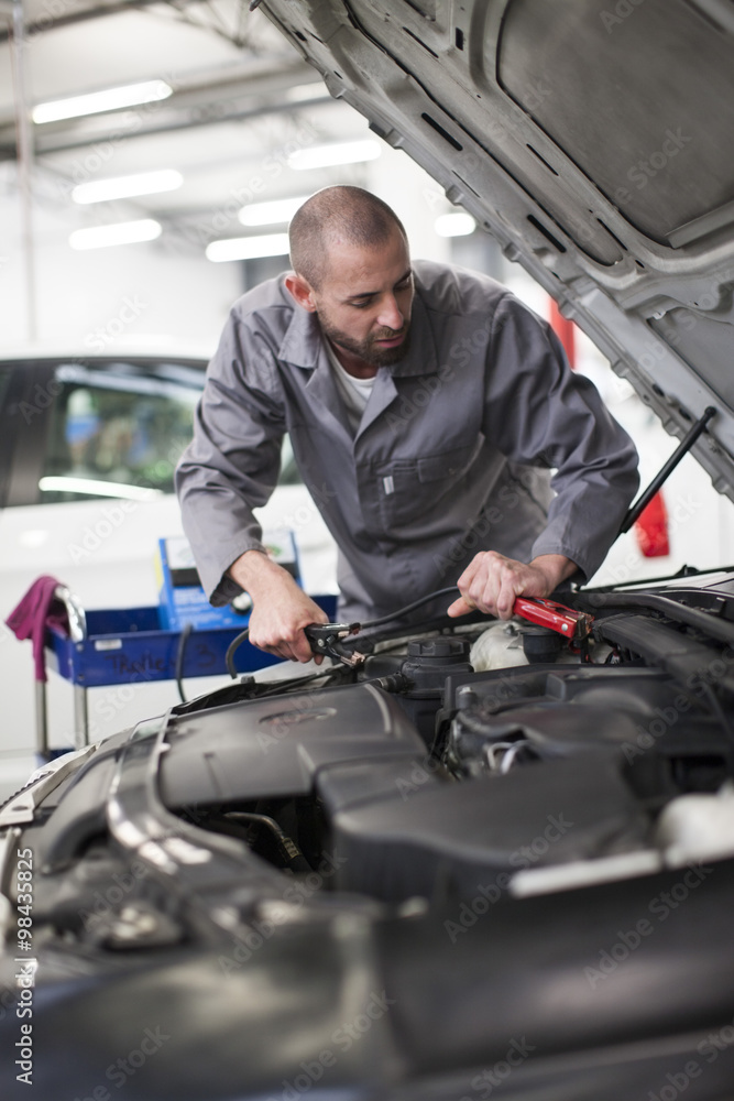 Car mechanic at work in repair garage Car mechanic at work in repair garage